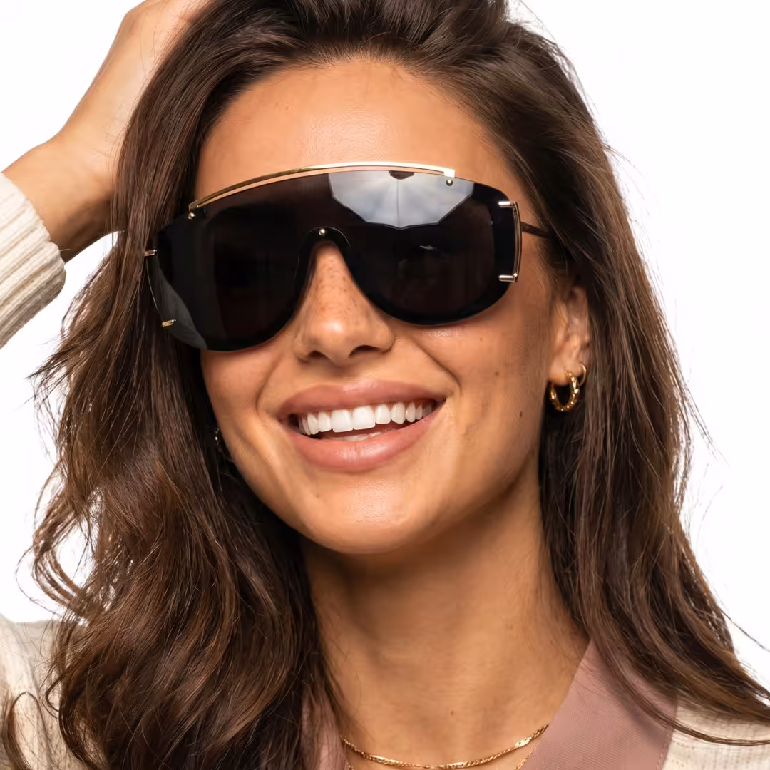 Front view of female wearing fashion black aviator sunglasses, hand in hair, smiling, AP0302605