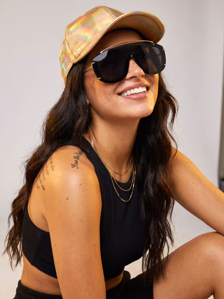 Female model wearing fashion black aviator pc sunglasses in an indoor minimalist photo studio with seamless plain off-white backdrop and warm gentle surrounding light. SPU: AP0302605