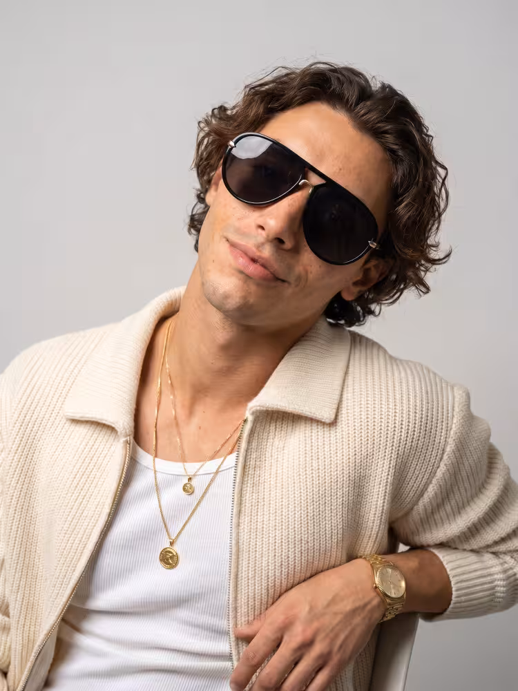 Male model wearing vintage black aviator pc sunglasses in a clean studio setting. SPU: AP0352604