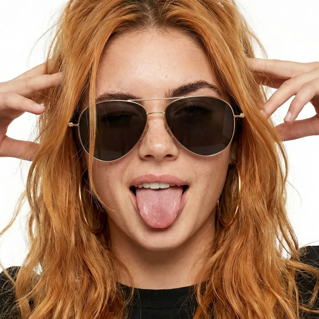 Front view of female wearing gray aviator sunglasses, sticking out tongue, natural expression, AT0262601S