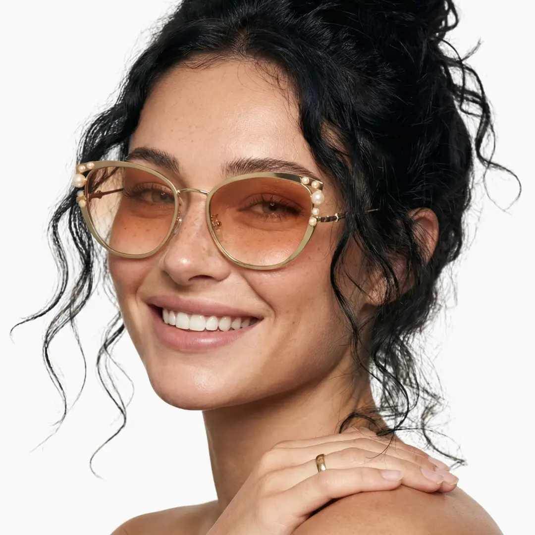 Front view of female wearing beige cat eye sunglasses, smiling, CM0042505