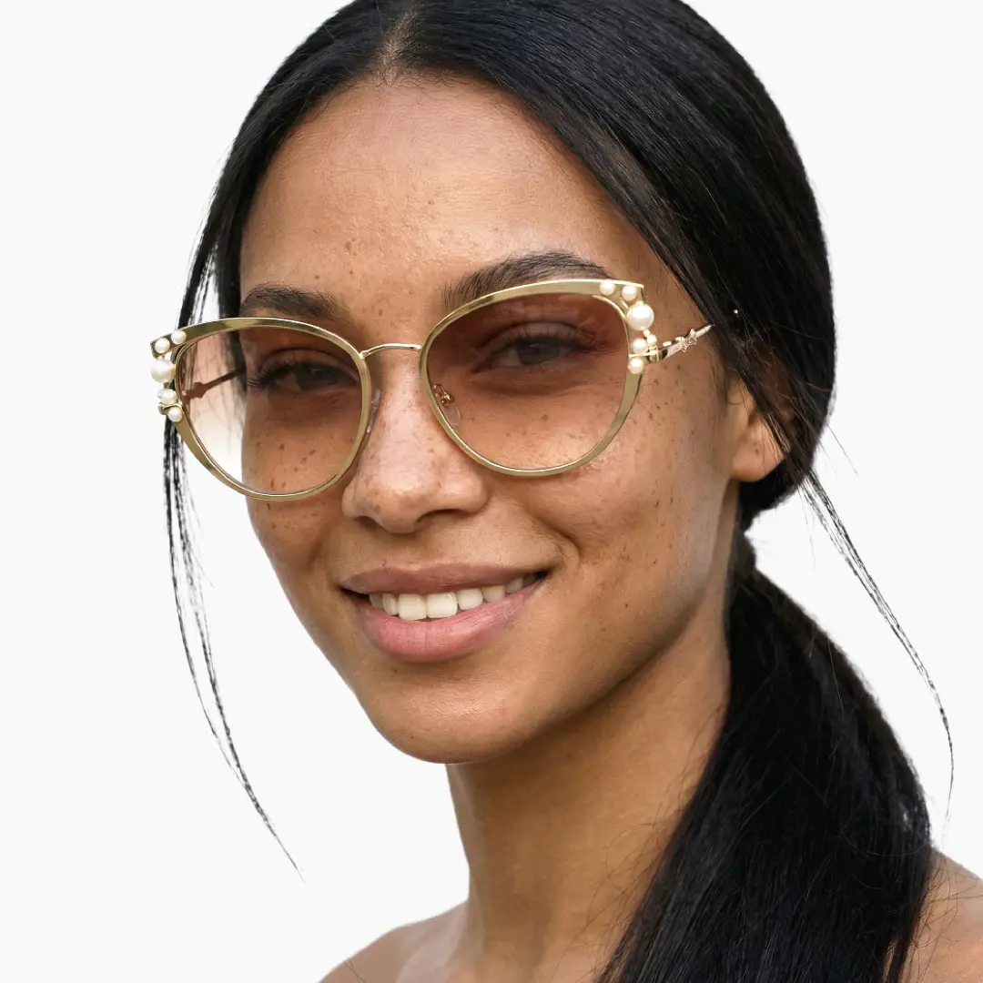 Front view of female wearing beige cat eye sunglasses, smiling, CM0042505