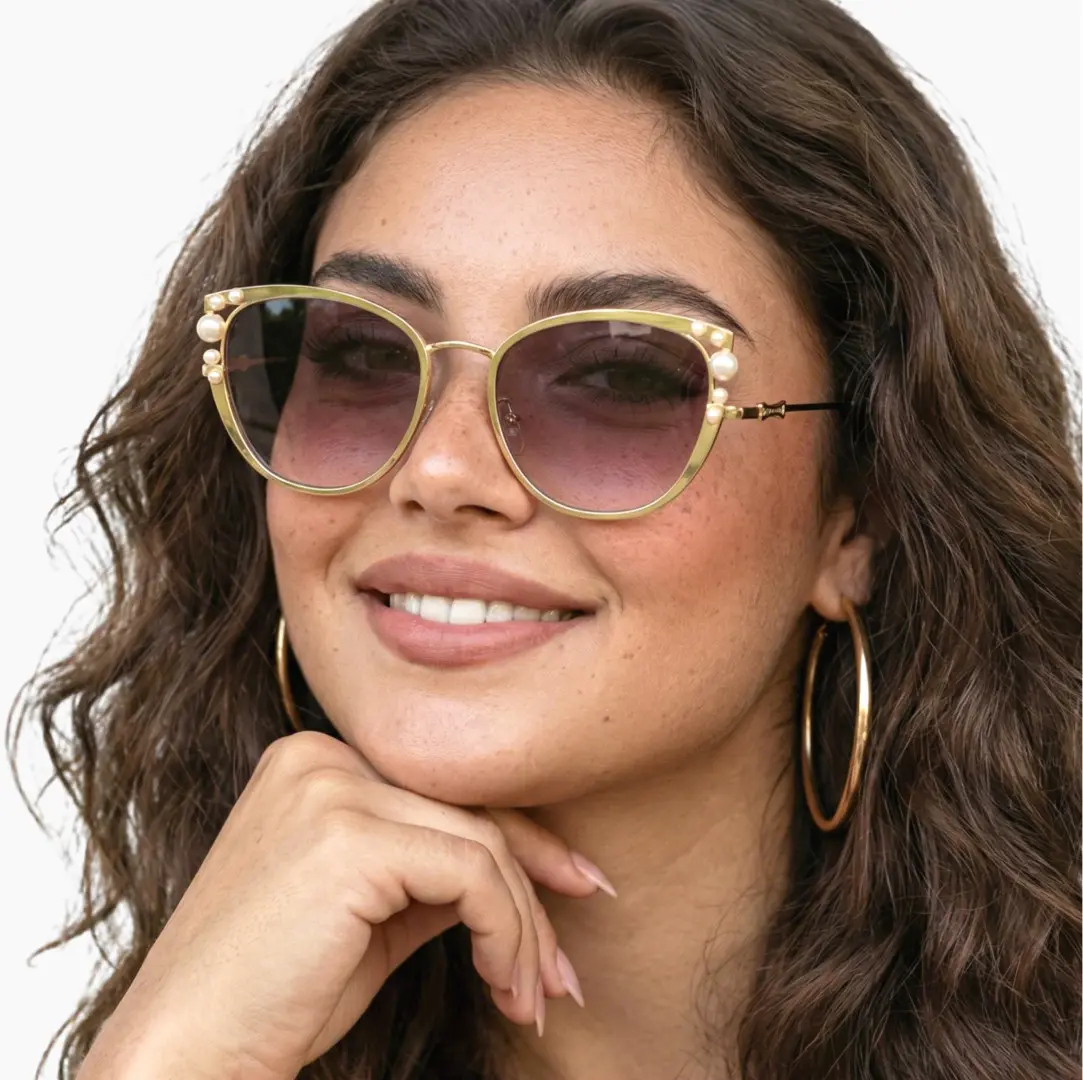 Front view of female wearing grey cat eye sunglasses, resting chin on hand, smiling, CM0042505