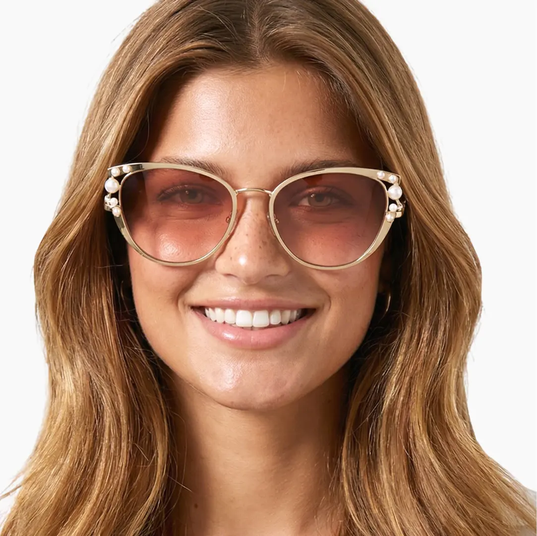 Front view of female wearing pink cat eye sunglasses, smiling, CM0042505