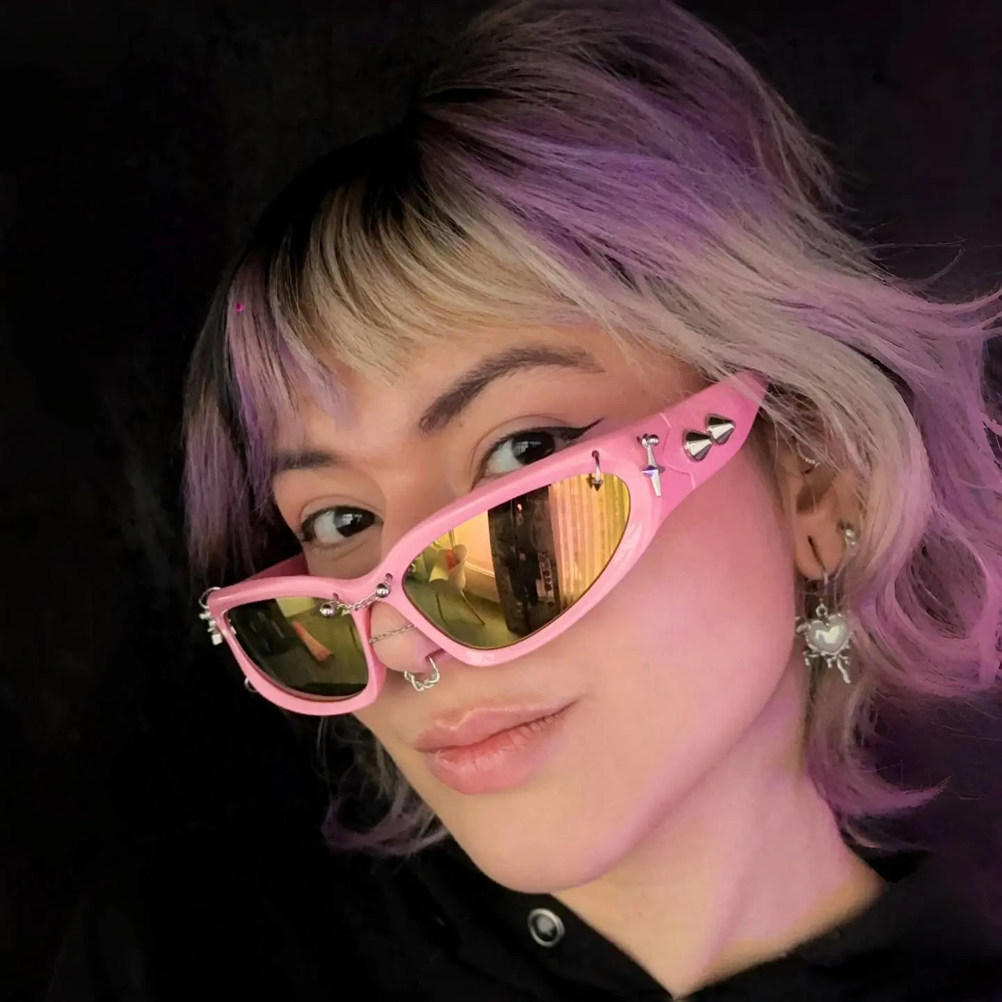 Face close-up of female wearing pink cat eye handcrafted polarized sunglasses, posing with head tilt, confident expression, CP0032511