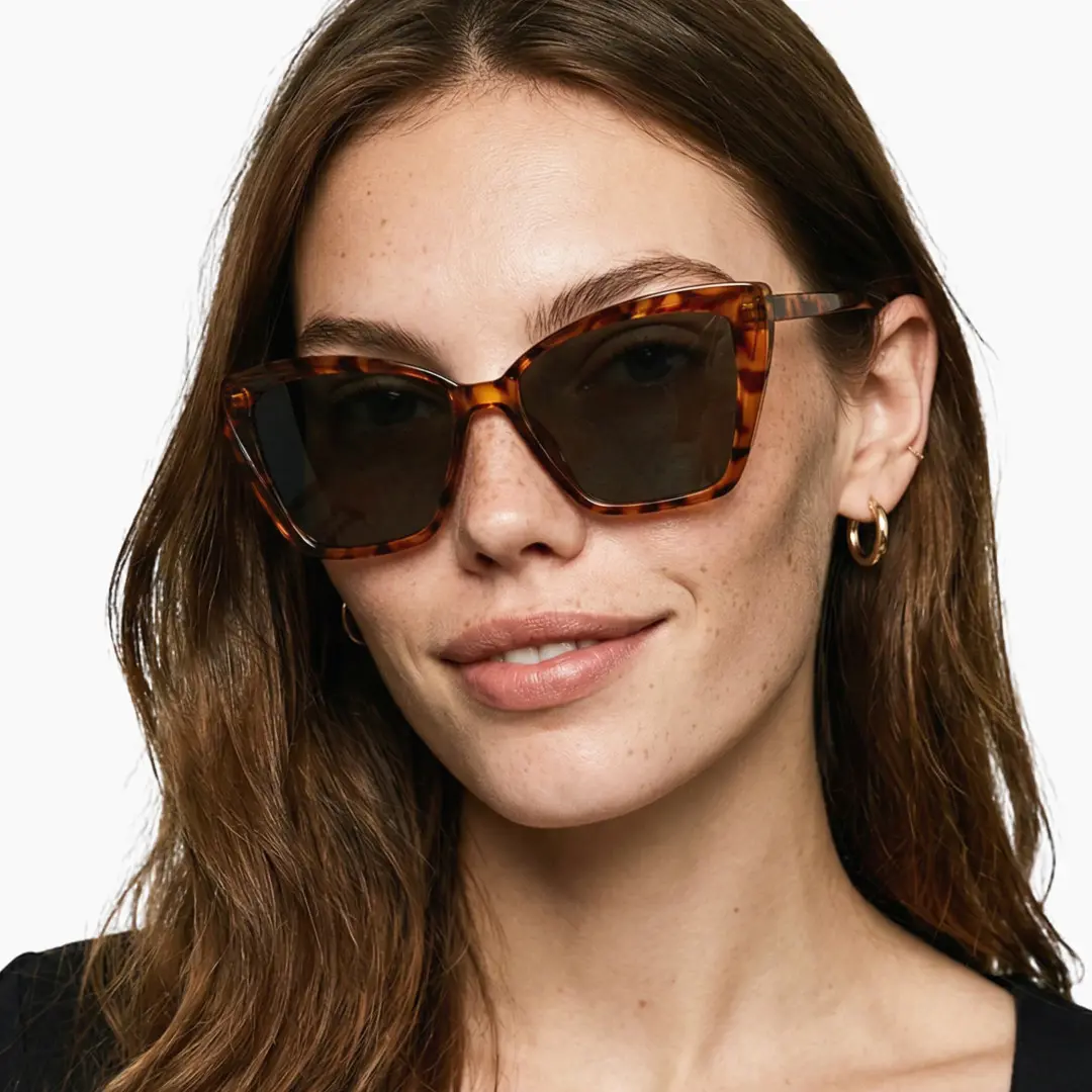 Front view of female wearing tortoise cat eye sunglasses, friendly smile, CP0102506