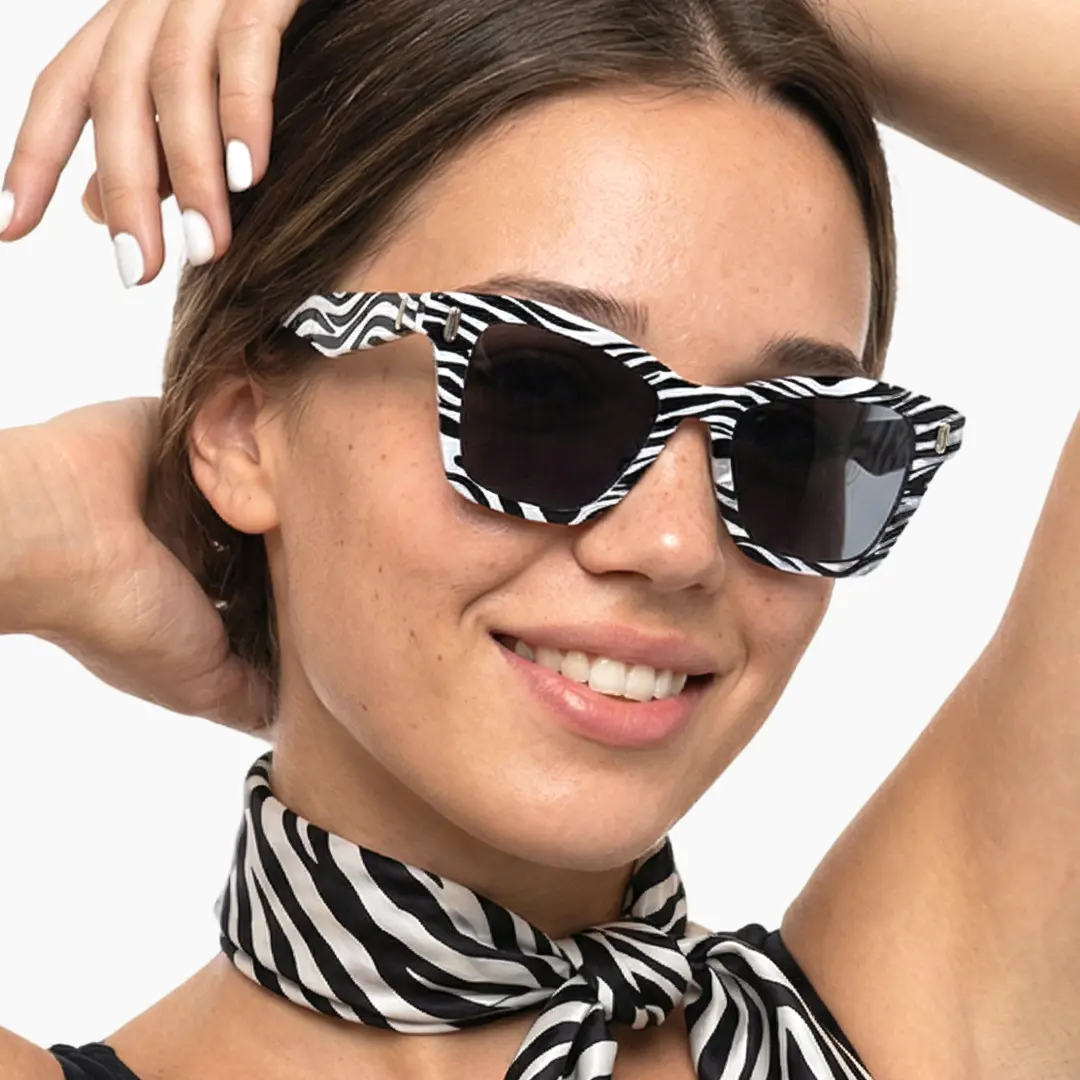 Profile view of female wearing black cat eye sunglasses, smiling, CP0122506