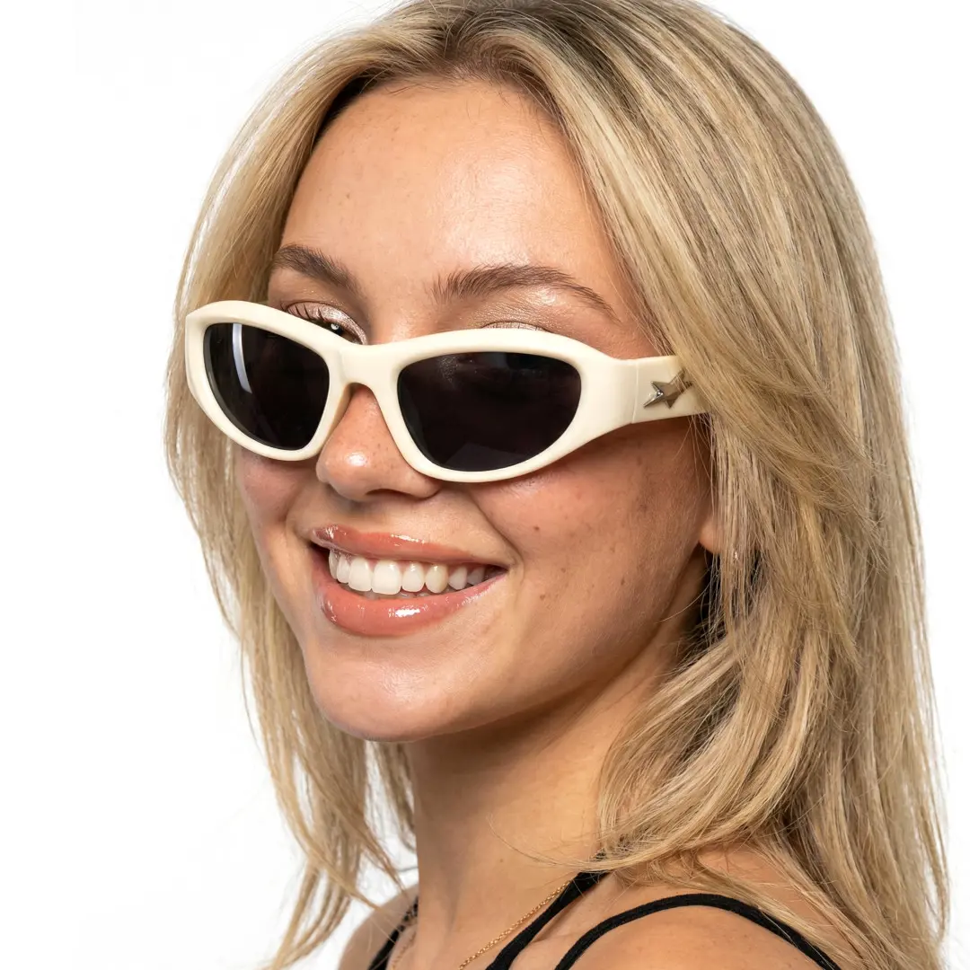 Over-the-shoulder view of female wearing y2k beige cat eye sunglasses, smiling, CP0302603