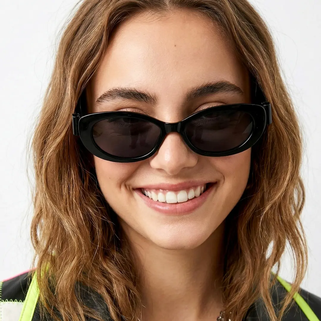Front view of female wearing black cat eye sunglasses, smiling, CP0332512