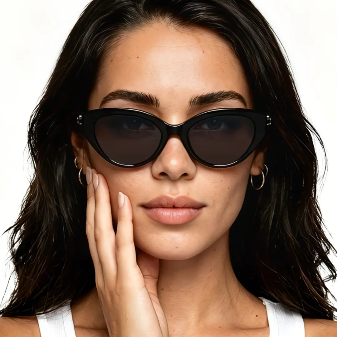 Front view of female wearing fashion black cat eye sunglasses, hand near face, neutral expression, CR0042604