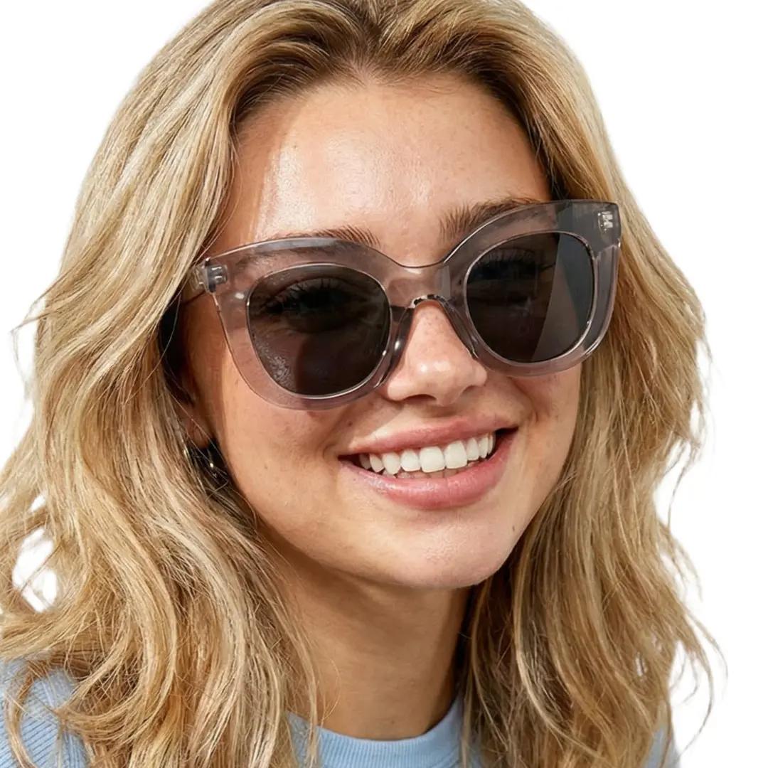 Three-quarter view of female wearing grey cat eye sunglasses, smiling, CR0172404
