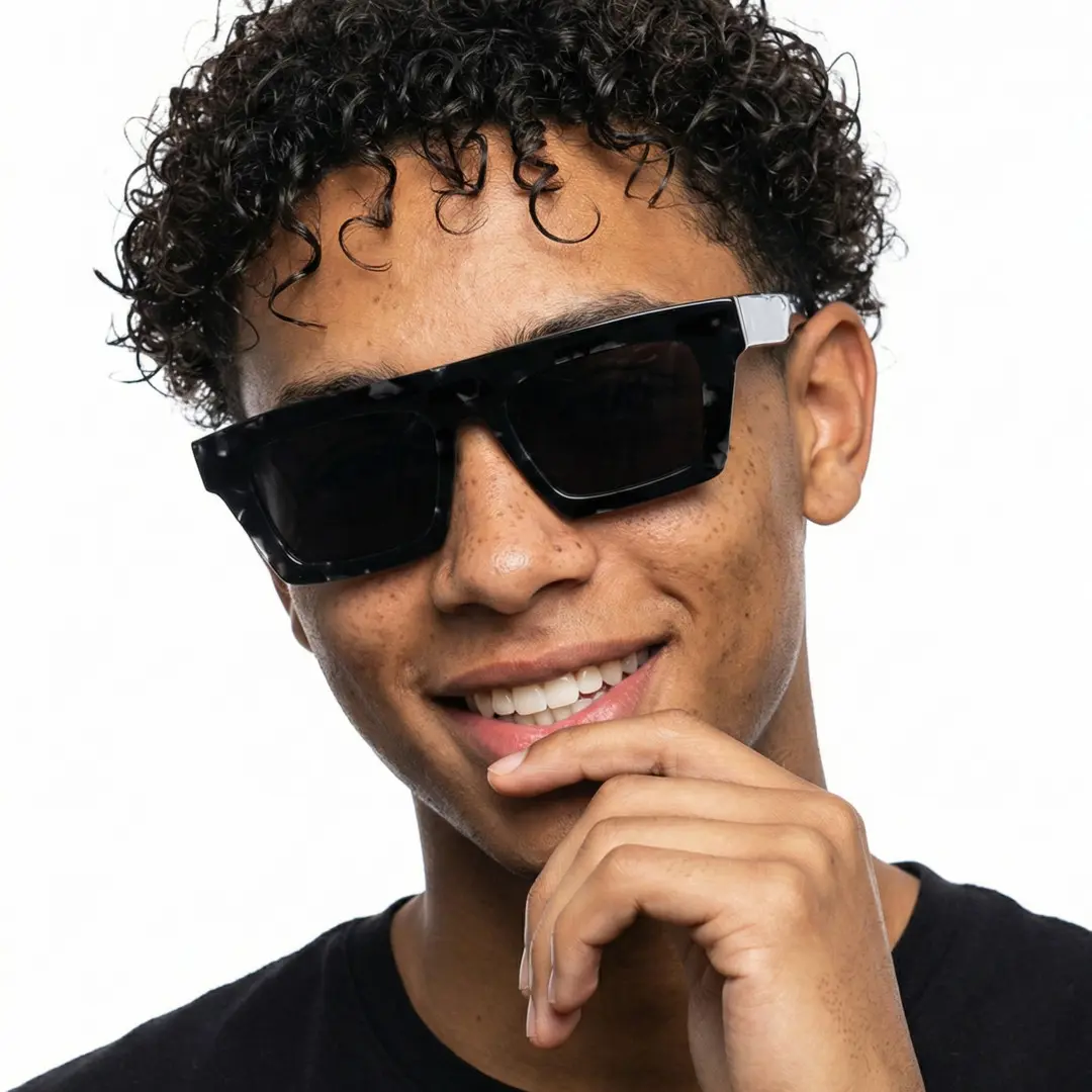 Front view of male wearing black rectangle sunglasses, resting chin on hand, smiling, EA0442508S