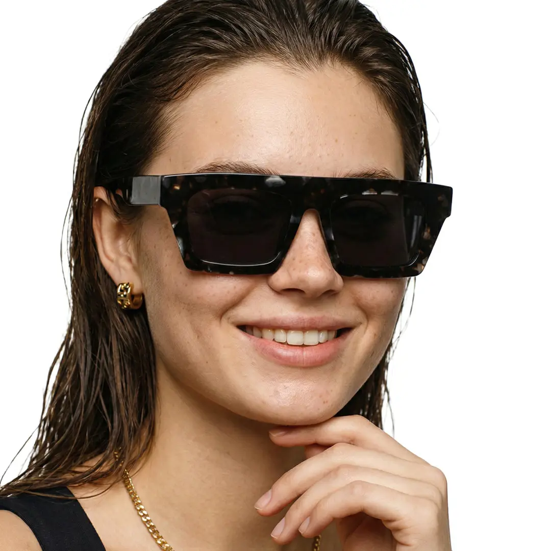 Front view of female wearing black rectangle sunglasses, resting chin on hand, natural smile, EA0442508S