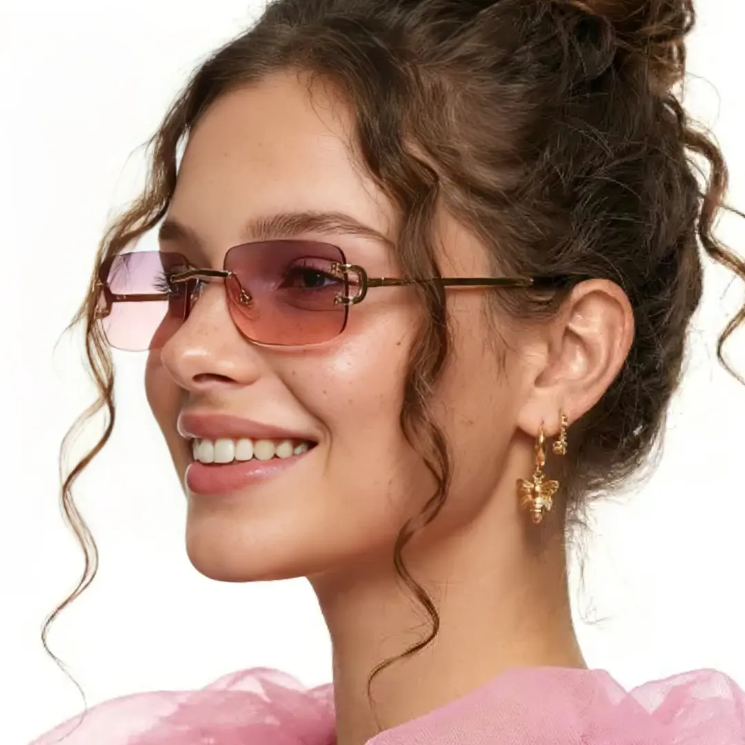 Three-quarter view of female wearing pink rectangle sunglasses, smiling, EM0122410