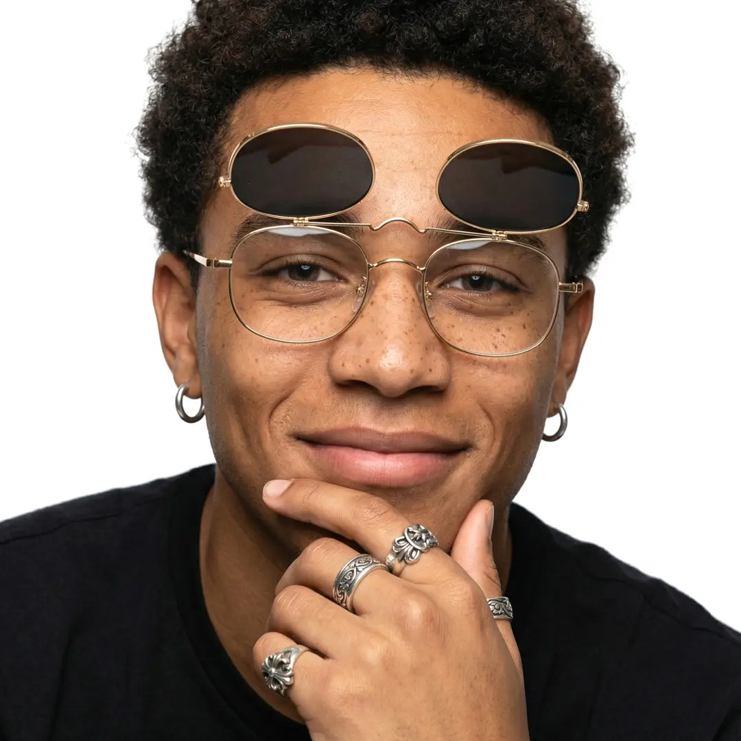 Male wearing gold rectangle metal flip-up eyeglasses, giving a subtle smile while cupping the chin. SPU: EM0122603