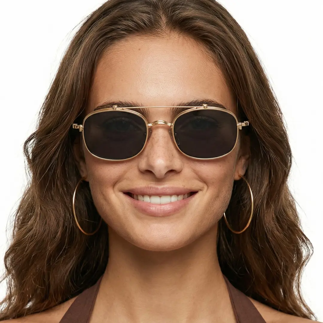 Female wearing gold rectangle metal flip-up eyeglasses, smiling while looking at camera. SPU: EM0122603