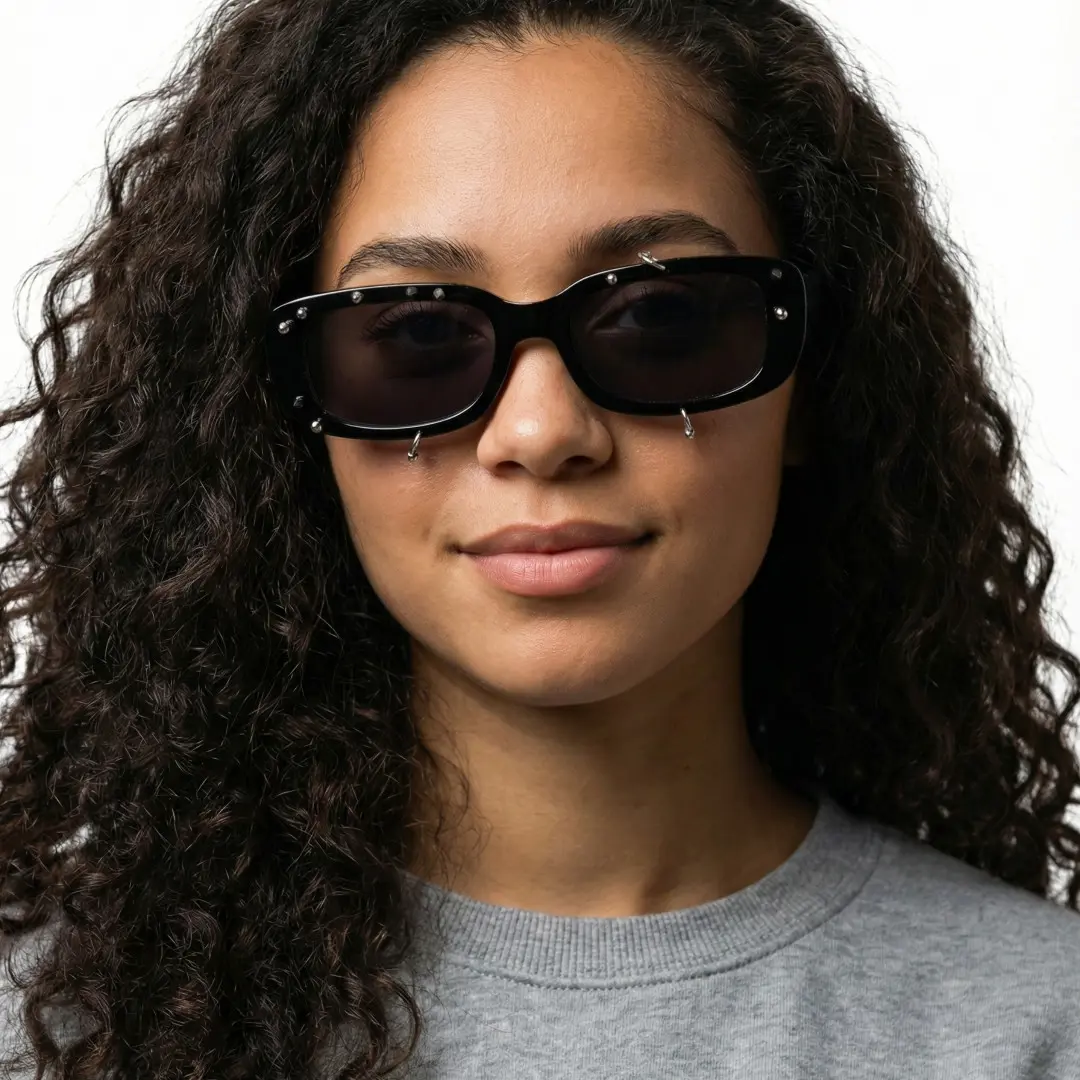 Front view of female wearing black rectangle sunglasses, soft smile, EP0022511