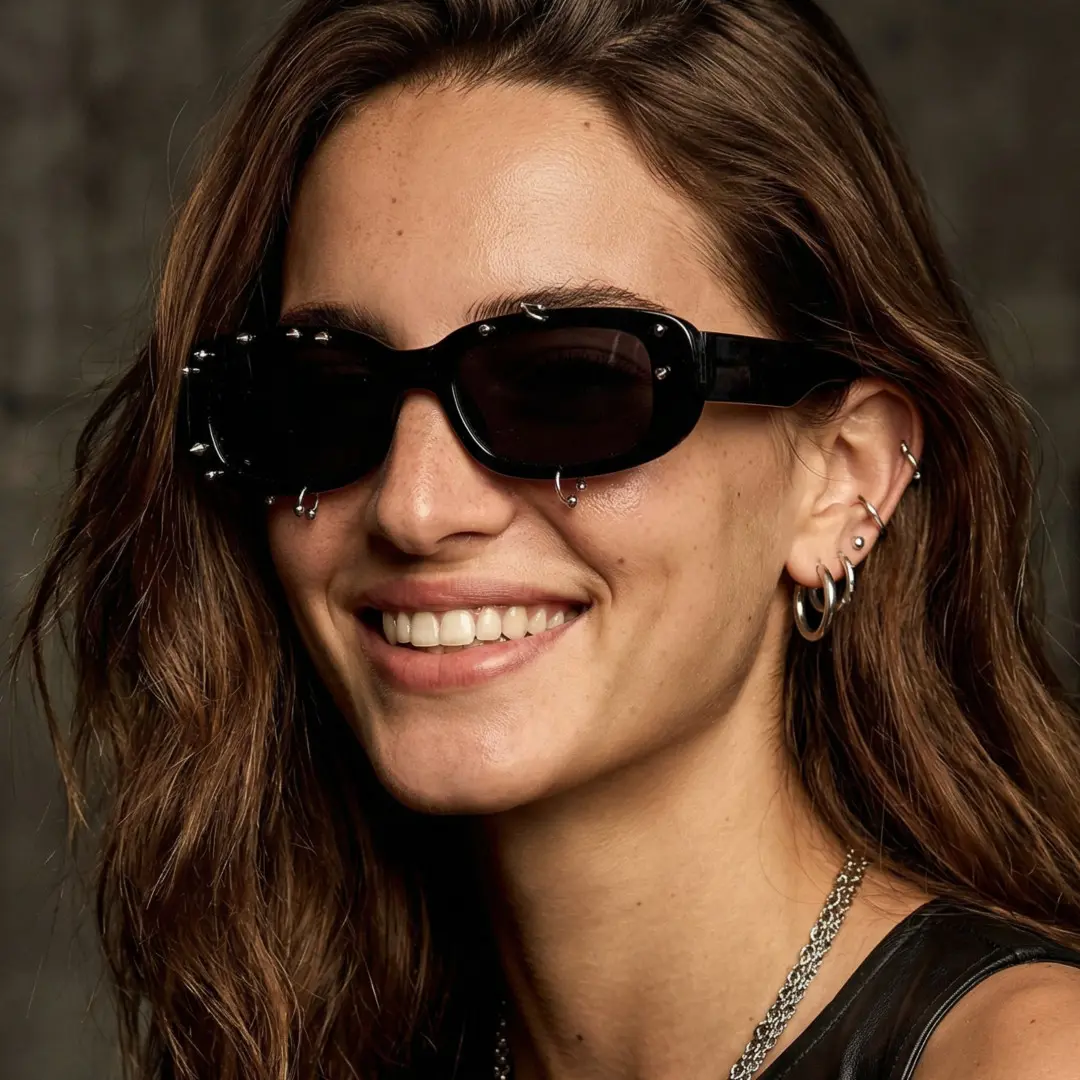 Three-quarter view of female wearing black rectangle sunglasses, smiling, EP0022511
