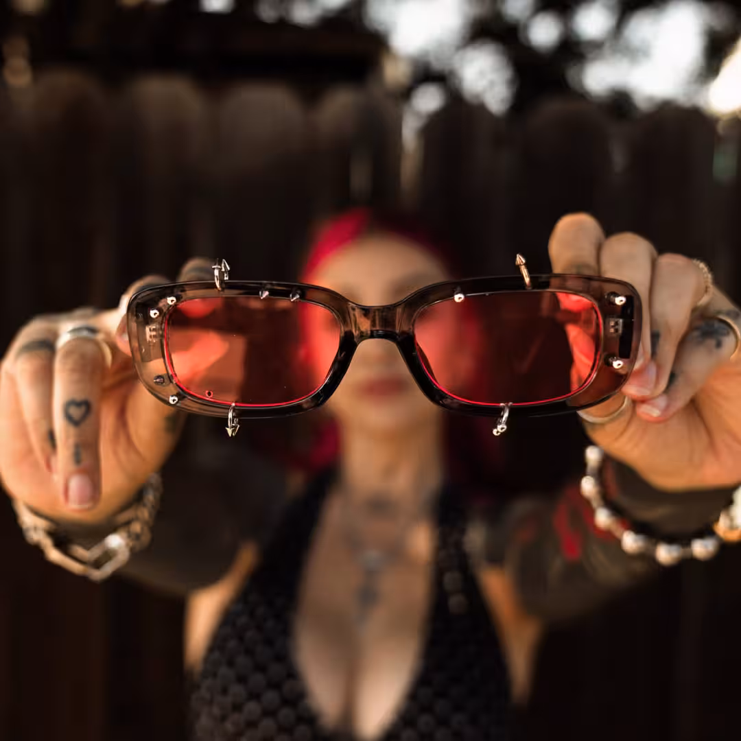 Female wearing grey rectangle pc handcrafted polarized sunglasses, maintaining a neutral expression while taking a selfie. SPU: EP0022511