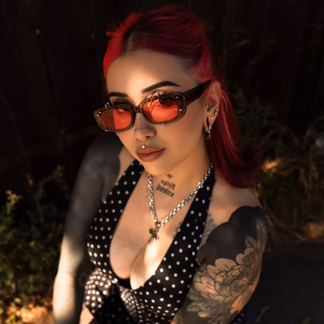 Female wearing grey rectangle pc handcrafted polarized sunglasses, giving a subtle smile while looking at camera. SPU: EP0022511