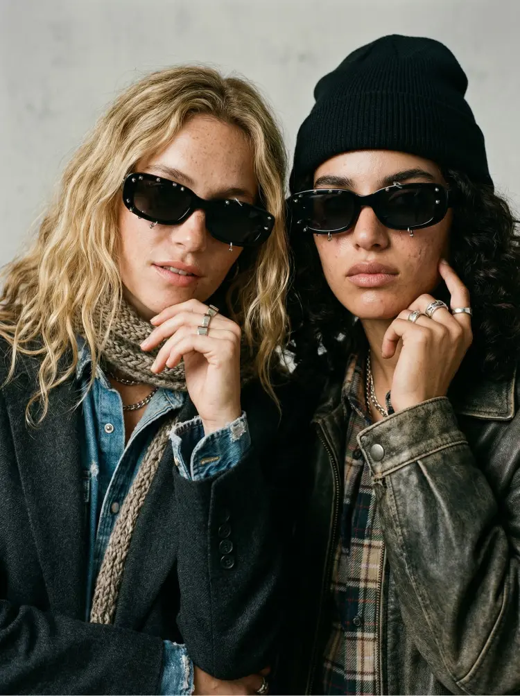 Two people model wearing handcrafted black rectangle pc handcrafted polarized sunglasses against a minimalist light grey wall background. SPU: EP0022511