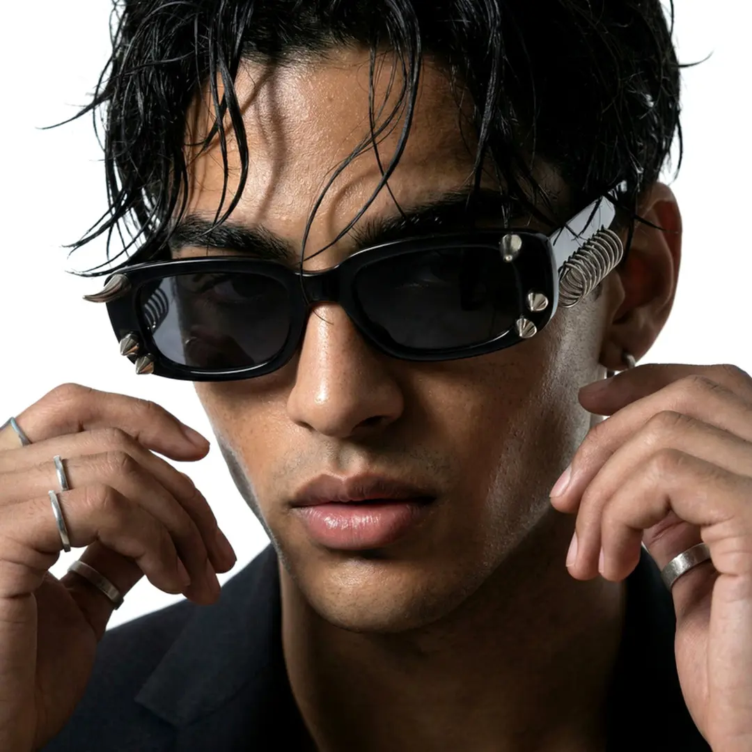 Front view of male wearing black rectangle handcrafted polarized sunglasses, hand near face, confident expression, EP0082601