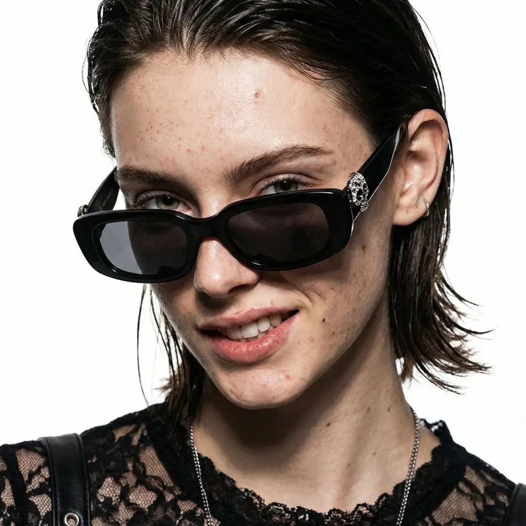 Slightly angled view of female wearing black rectangle sunglasses, natural expression, EP0092511