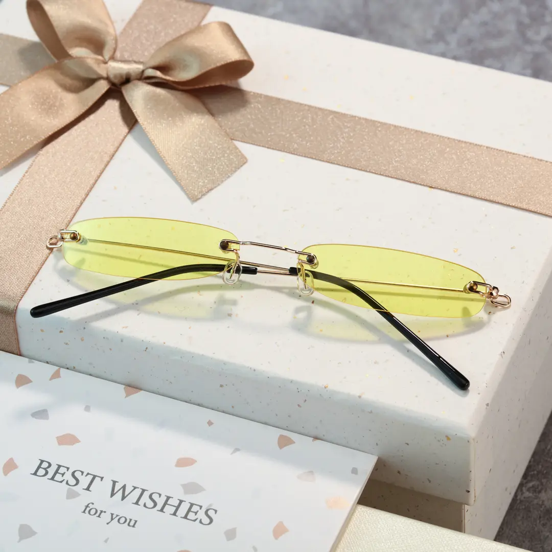 Female wearing y2k yellow rectangle pc sunglasses, natural smile while resting chin on hand. SPU: EP0112410