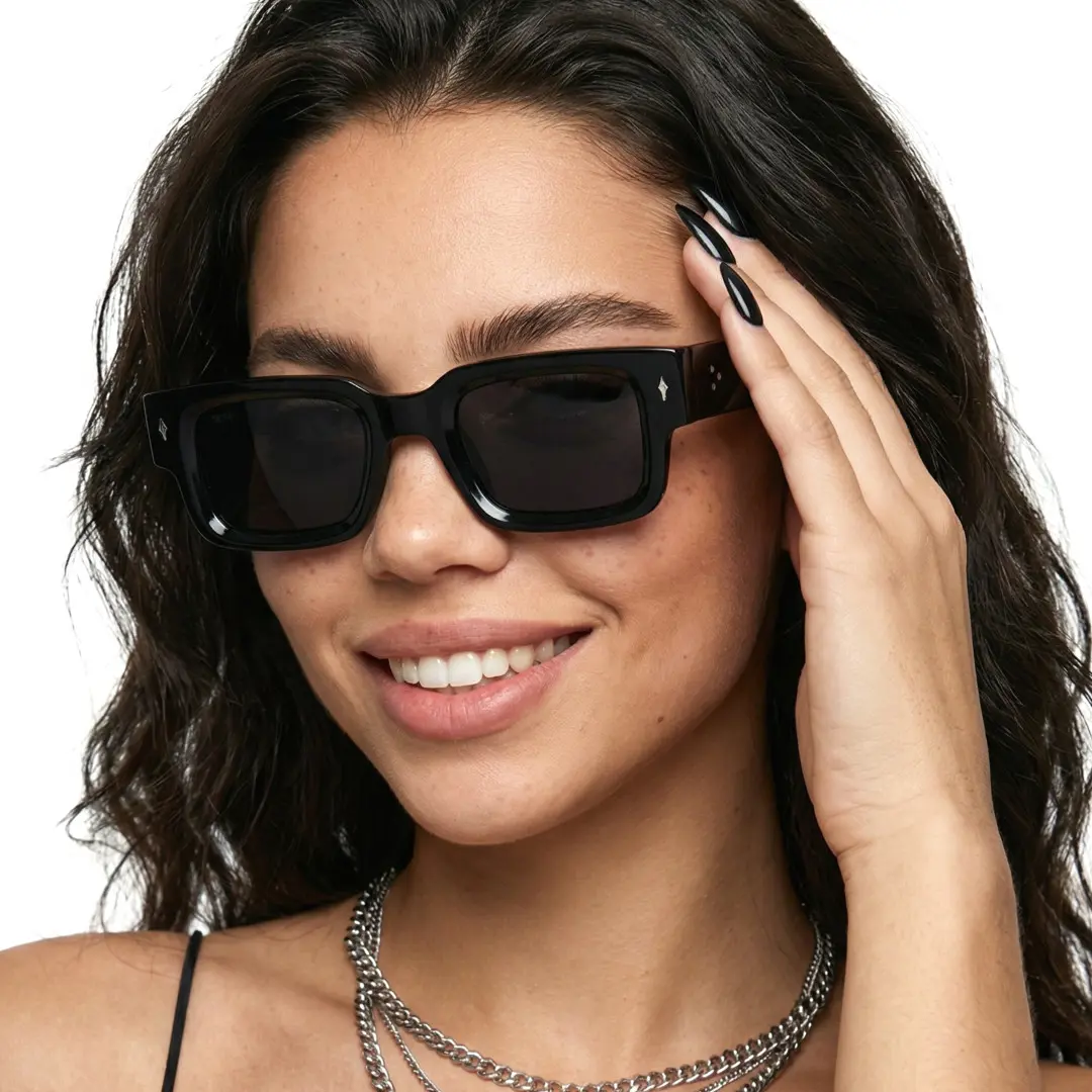 Three-quarter view of female wearing black rectangle sunglasses, smiling, EP0542509S