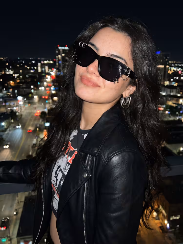 Female model wearing handcrafted silver rectangle tr90 handcrafted polarized sunglasses in a night city setting. SPU: ER0072604