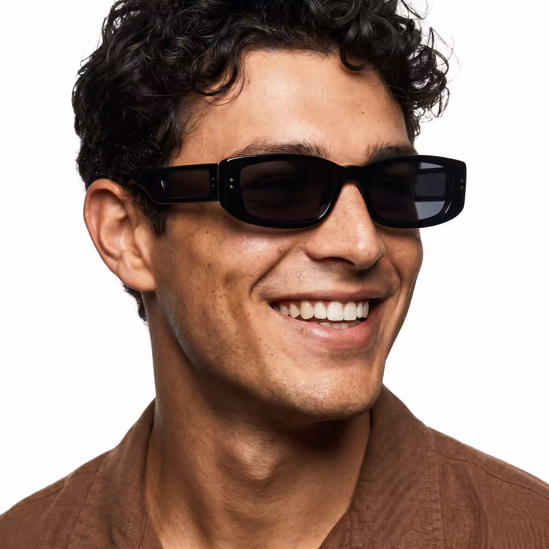 Profile view of male wearing fashion black rectangle sunglasses, smiling, ER0132604