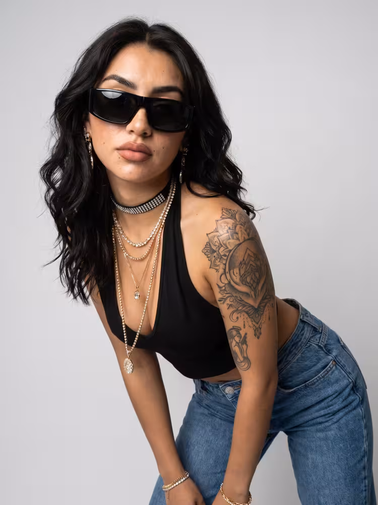 Female model wearing Y2K black rectangle TR90 sunglasses in a clean studio setting. SPU: ER0132605