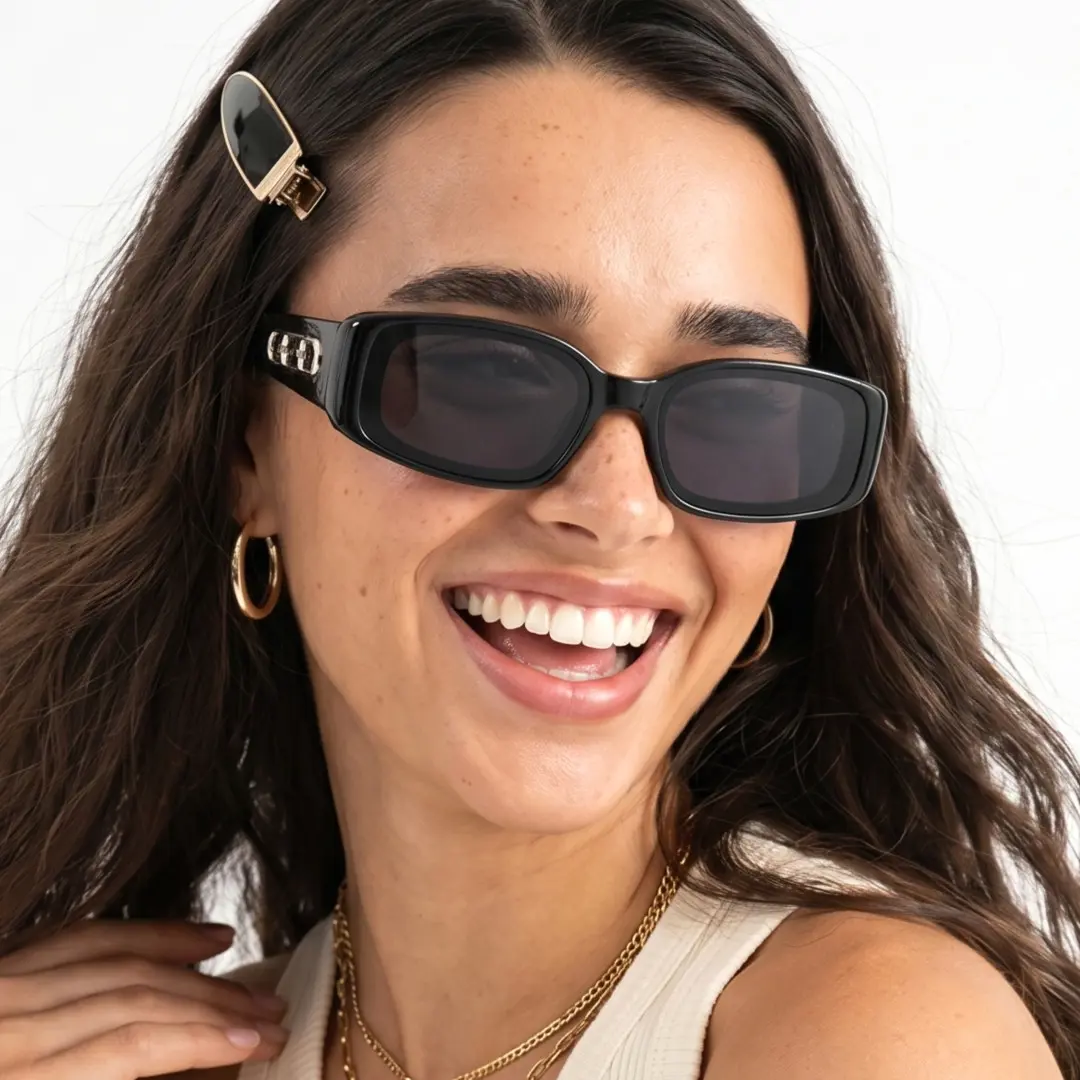Three-quarter view of female wearing fashion black rectangle sunglasses, hand in hair, big smile, ER0142604