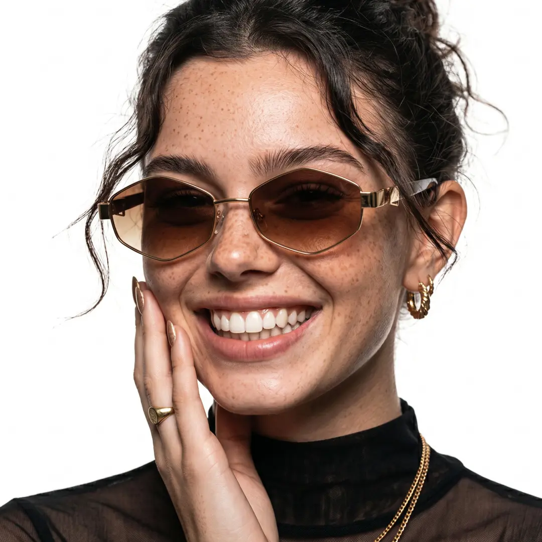 Three-quarter view of female wearing gold geometric sunglasses, hand touching face, smiling, GM0282603