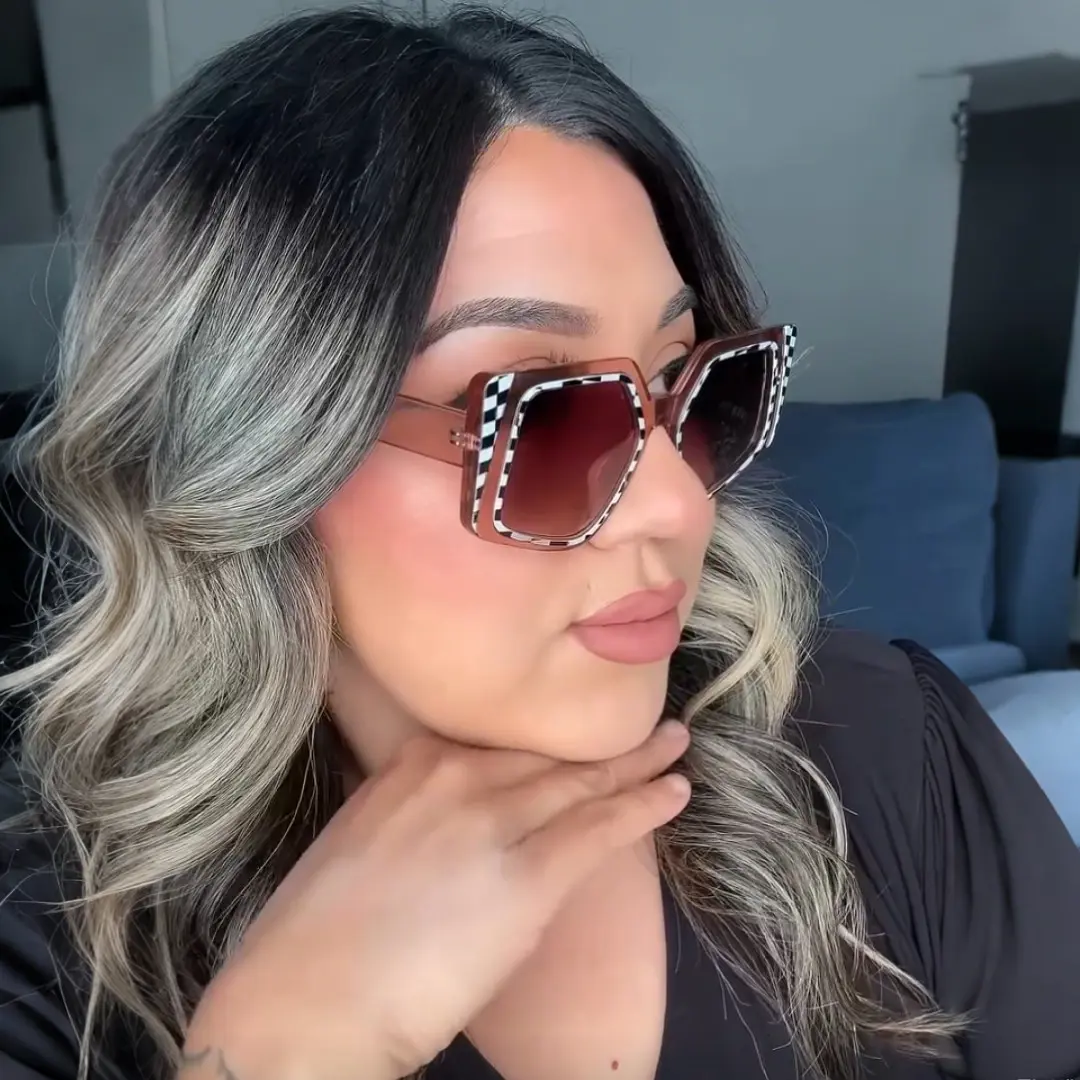 Looking away view of female wearing fashion brown geometric sunglasses, neutral expression, GP0222507