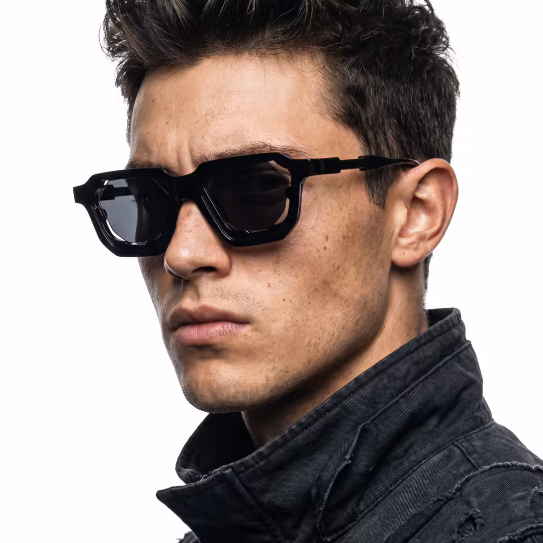 Male wearing fashion black geometric pc sunglasses, maintaining a neutral expression while looking at camera. SPU: GP0482605