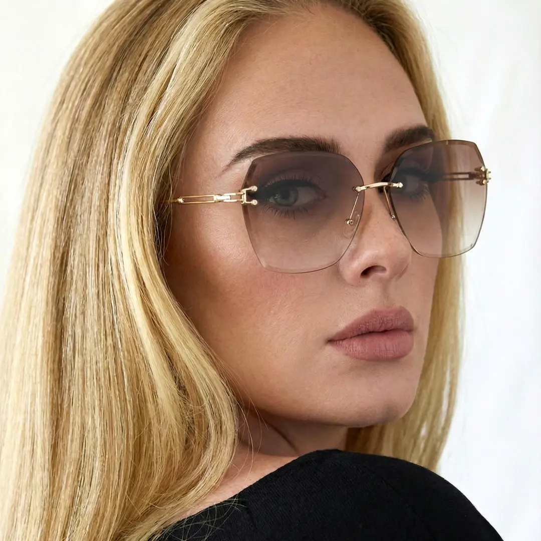 Over-the-shoulder view of female wearing brown geometric sunglasses, neutral expression, GX0082505