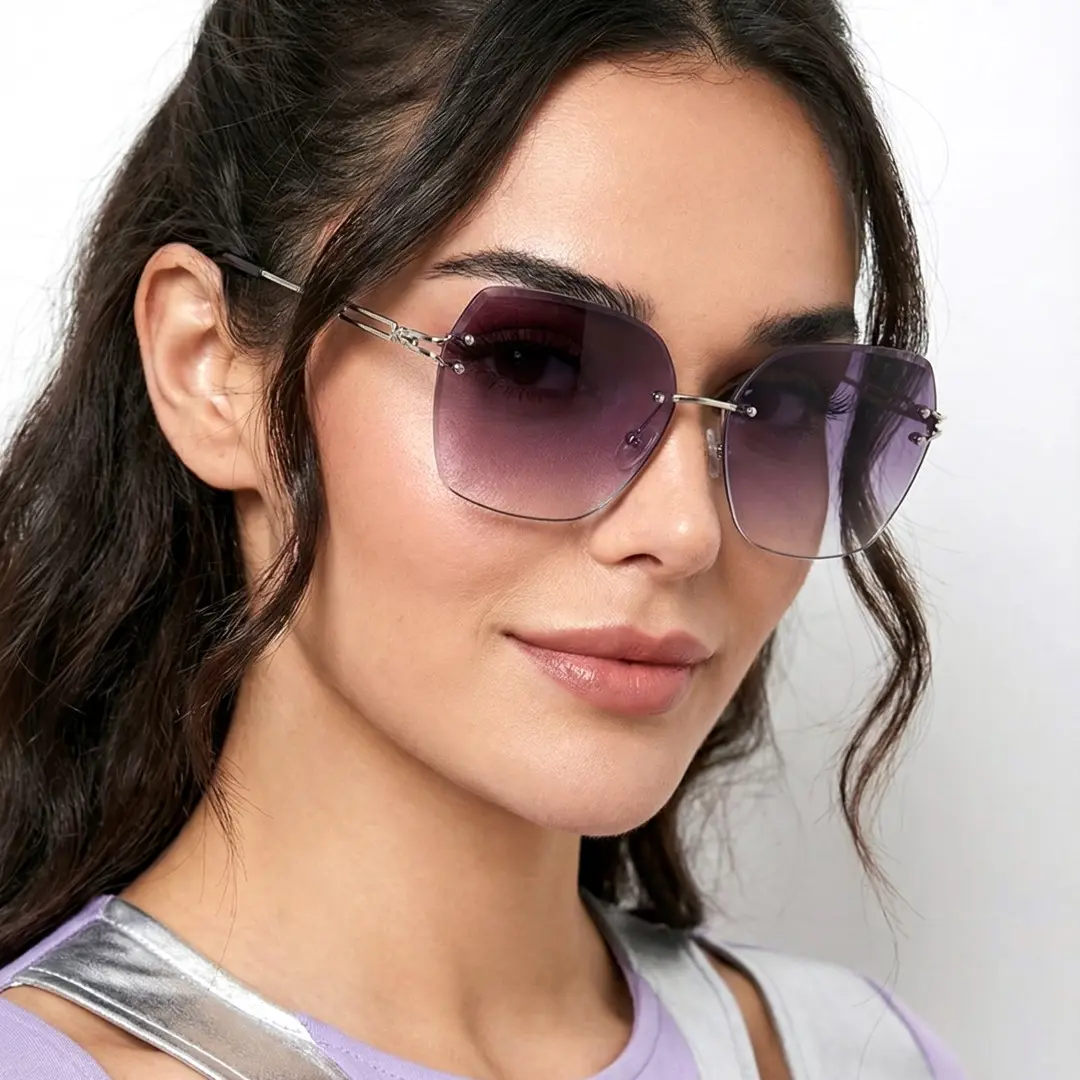 Three-quarter view of female wearing grey geometric sunglasses, smiling, GX0082505