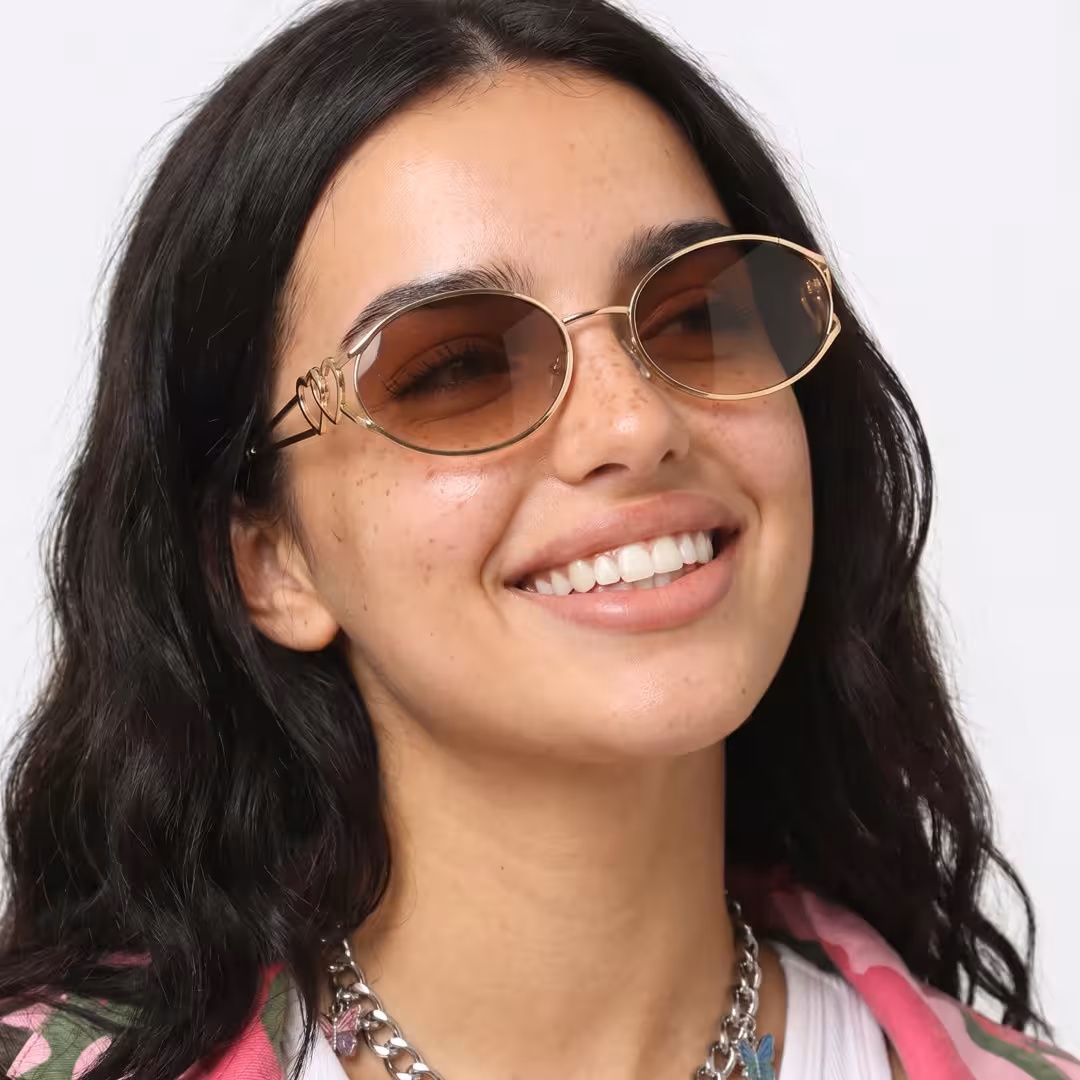 Female wearing y2k gold oval metal sunglasses, smiling. SPU: OM0162603