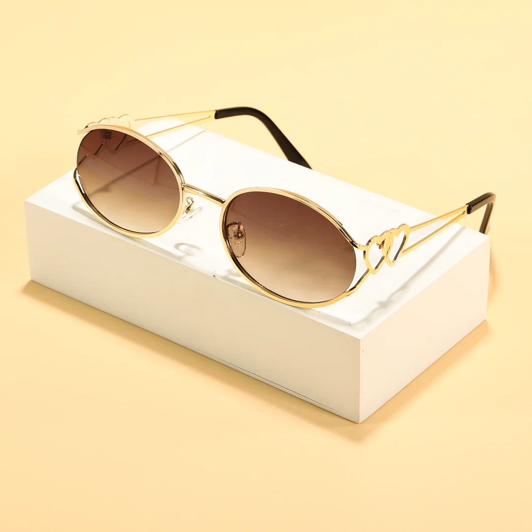 Scene view of Cressida y2k oval metal sunglasses OM0162603 in gold