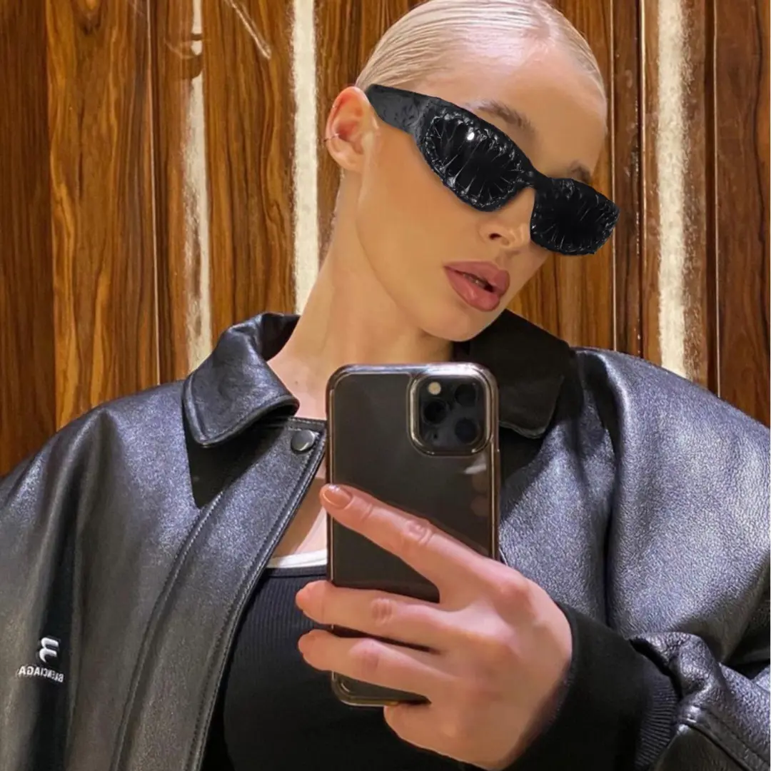 Profile view of female wearing black oval sunglasses, natural expression, OP0102511