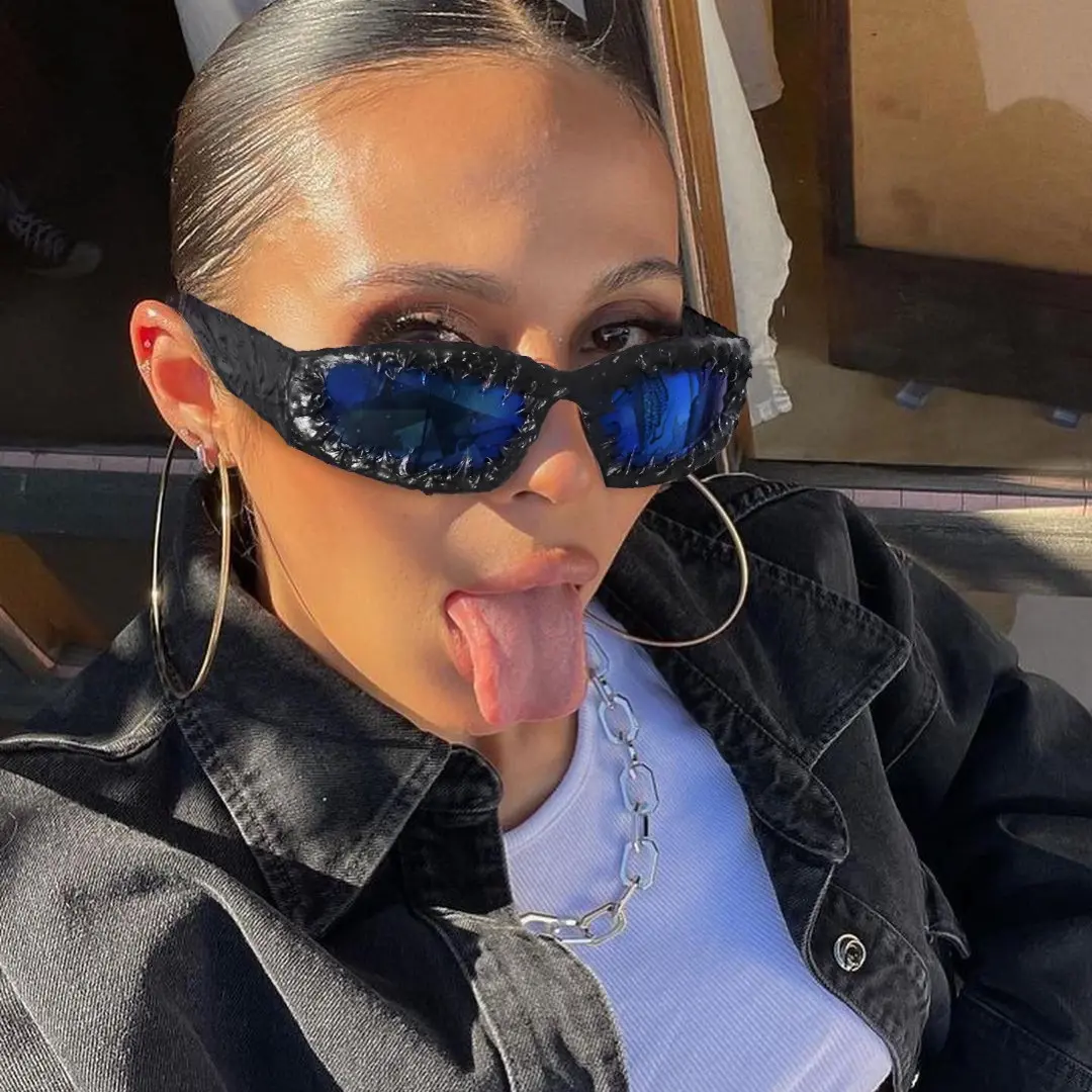 Three-quarter view of female wearing black oval sunglasses, sticking out tongue, OP0102511