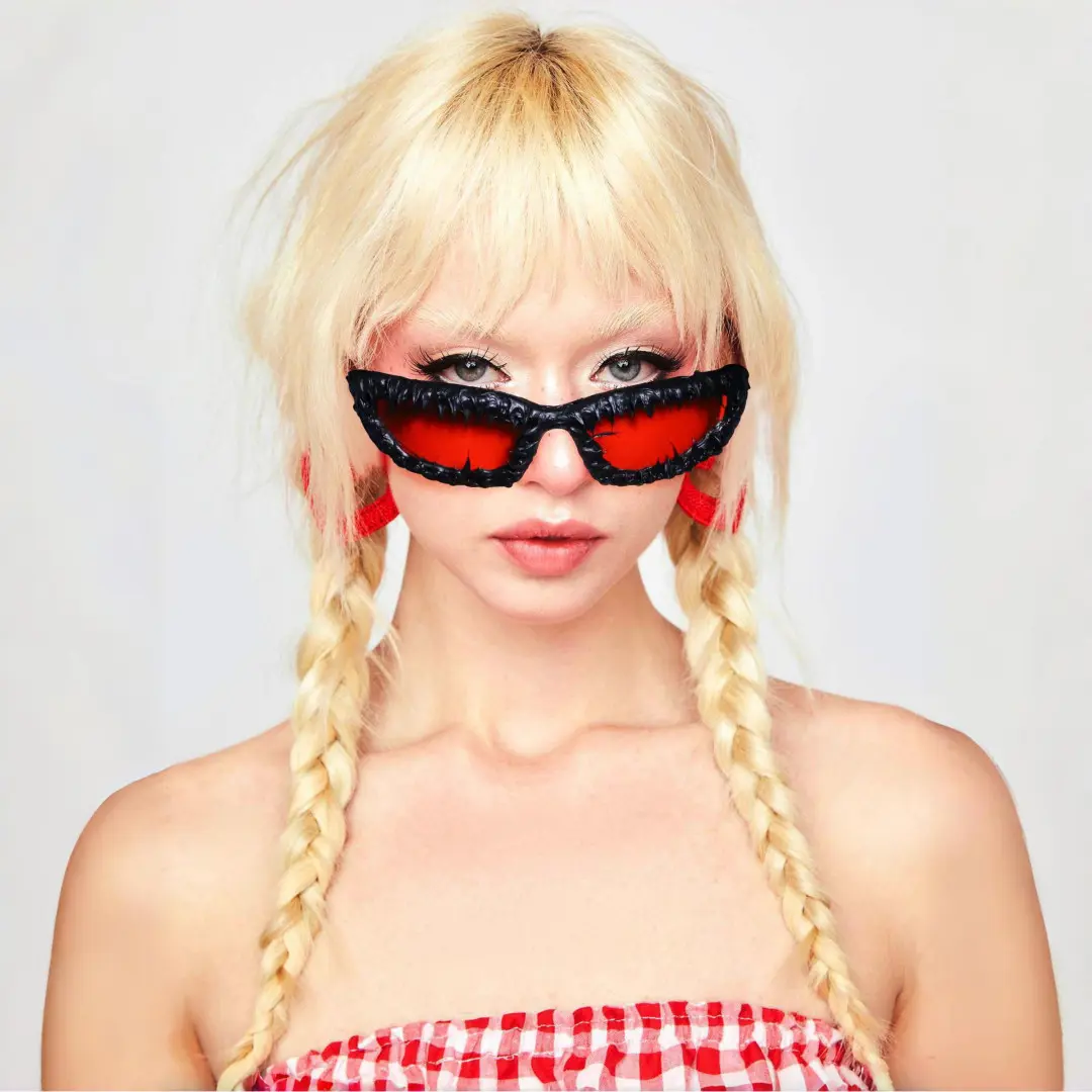 Front view of female wearing red oval sunglasses, neutral expression, OP0102511
