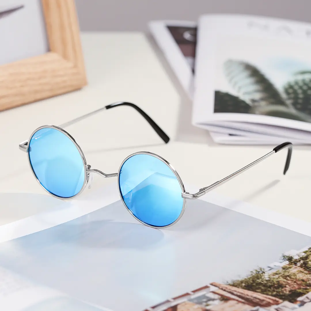Scene close-up view of Kaleb round metal sunglasses RM0012207 in silver blue