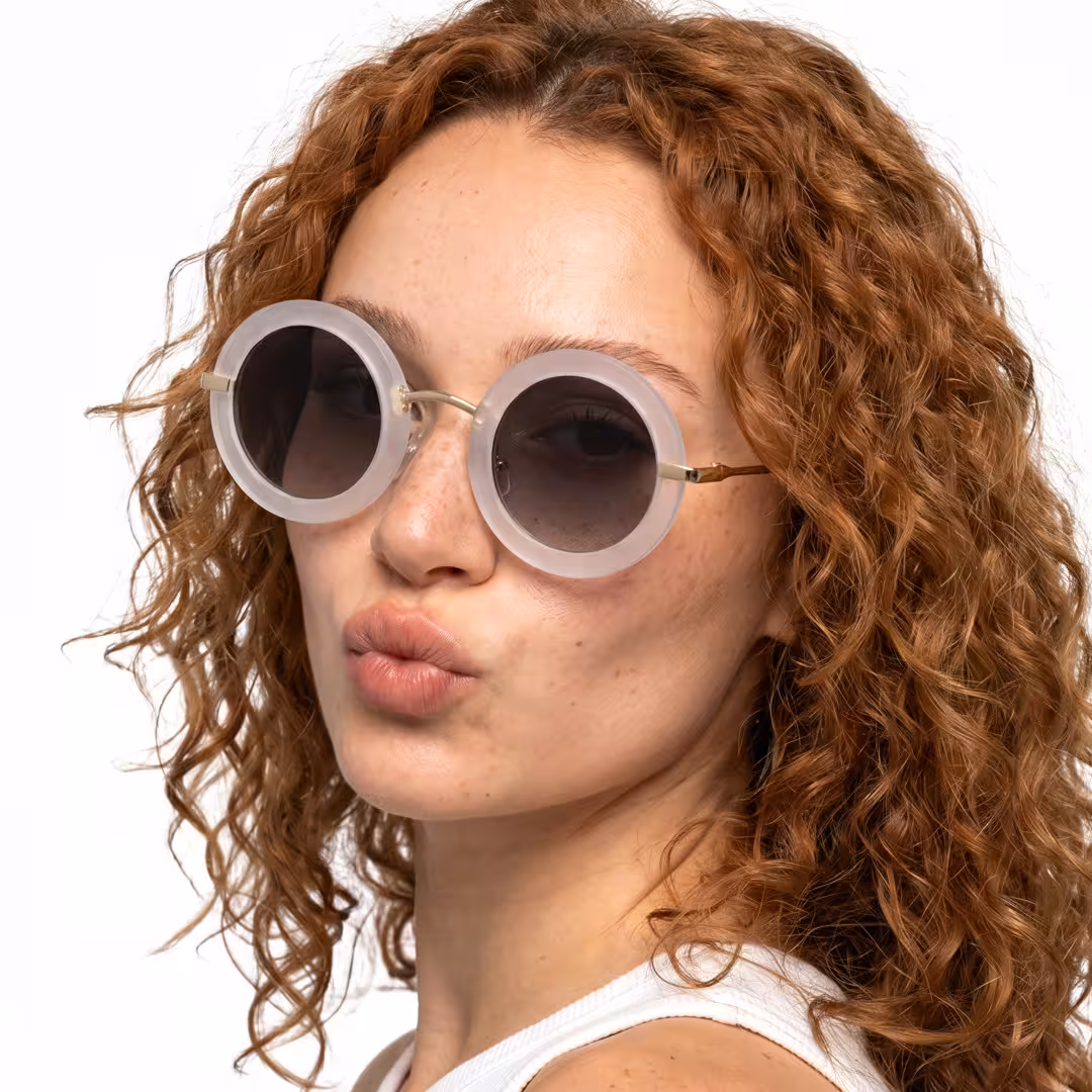 Female wearing vintage gold round metal sunglasses, pouting. SPU: RM0012605