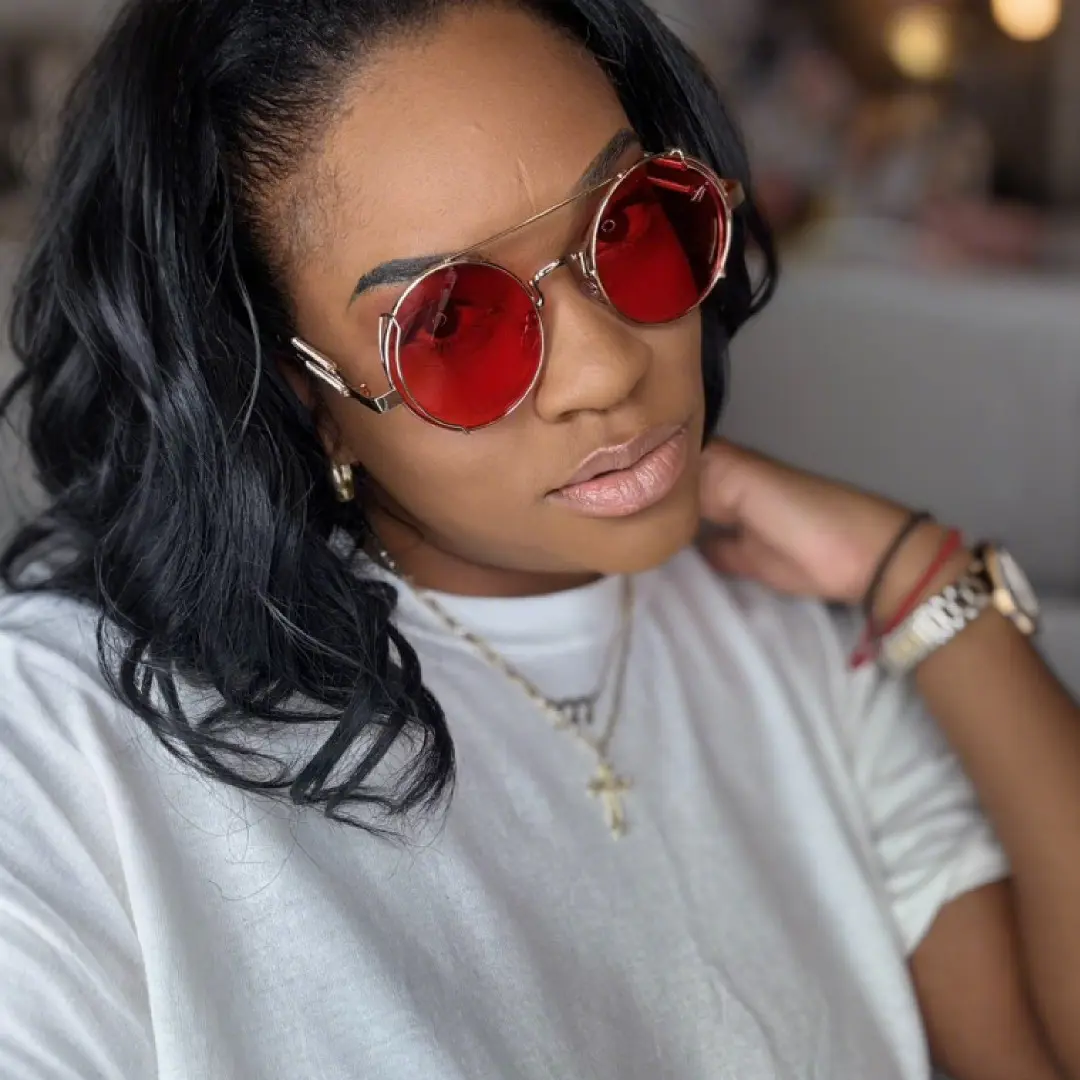 Front view of female wearing steampunk red round sunglasses, taking a selfie, neutral expression, RM0102303