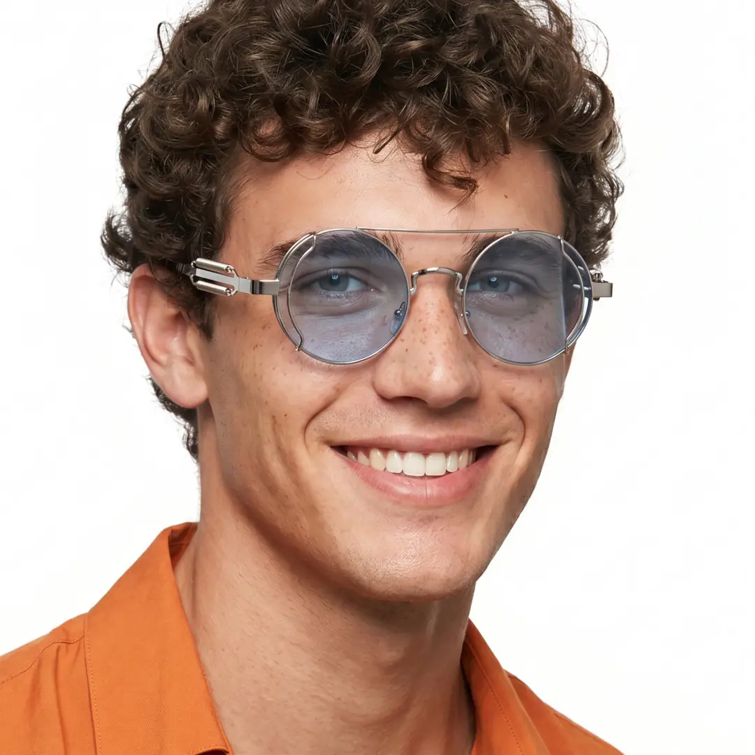 Three-quarter view of male wearing steampunk silver blue round sunglasses, smiling, RM0102303