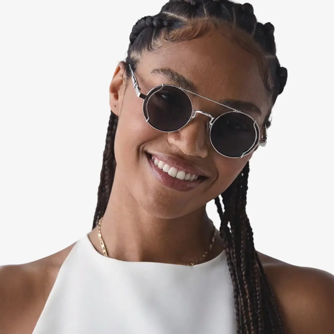Front view of female wearing silver round sunglasses, Tilting head, wide smile, RM0102303