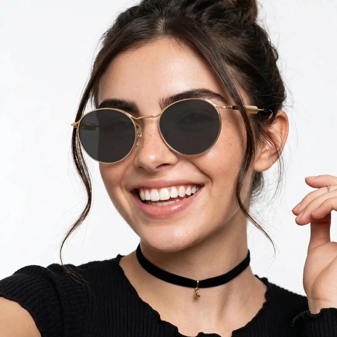 Slightly angled view of female wearing steampunk gray round sunglasses, smiling, RM0262603