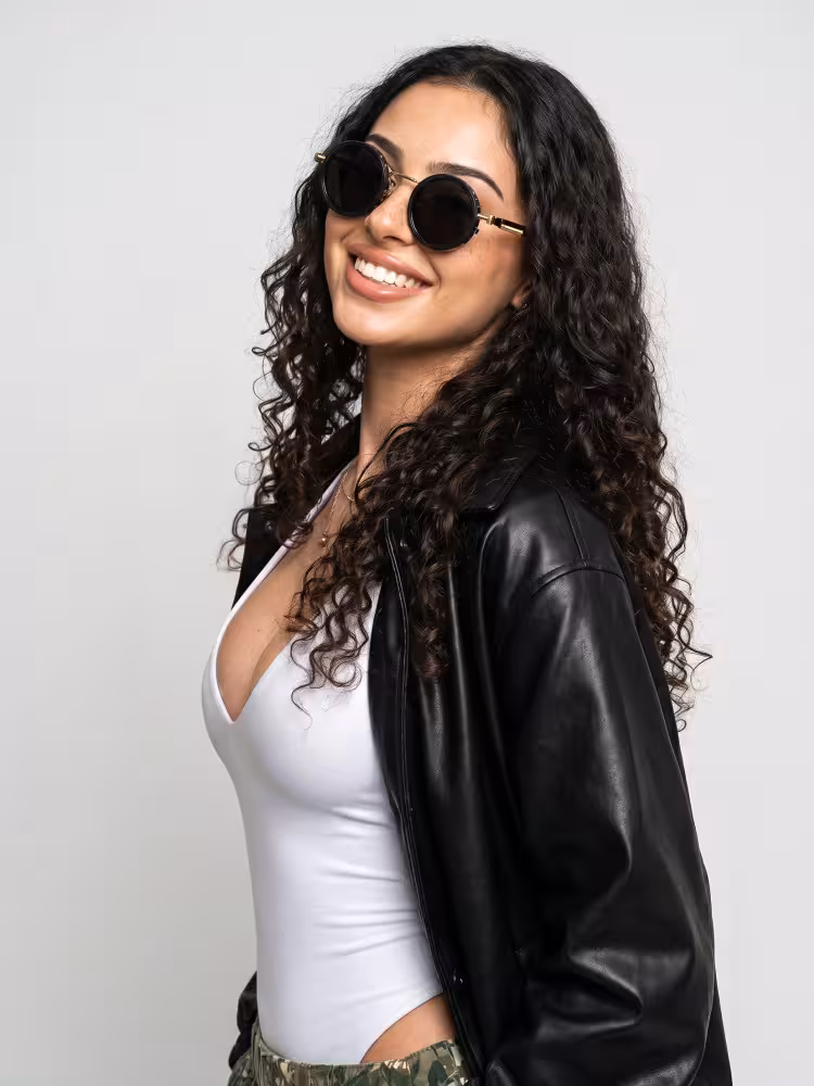 Female model wearing steampunk gold round metal sunglasses in an indoor portrait studio with smooth solid light gray seamless backdrop. SPU: RM0312605